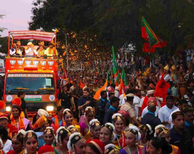 Women throw mobile along with flowers at Modi during rally