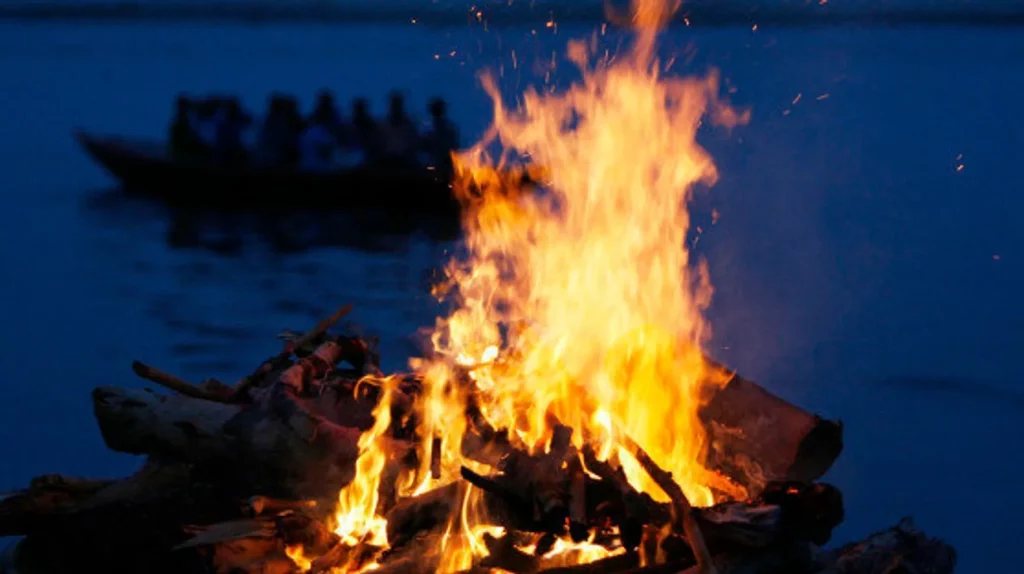 Why is a baton beaten on the head during funerals