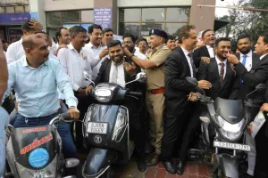 Free distribution of 1500 neck safety belts by RTO-Surat to protect motorists from kite string under National Safety Month