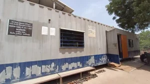 Polling station set up in shipping container for voters of Aliabet surrounded by water