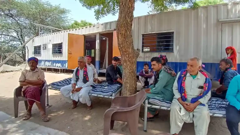 Polling station set up in shipping container for voters of Aliabet surrounded by water