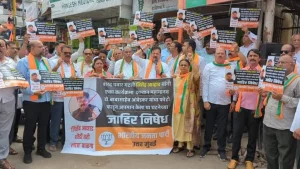 Posters of Nationalist Congress (NCP) Sharad Pawar group leader Jitendra Awhad burn shoes during protest